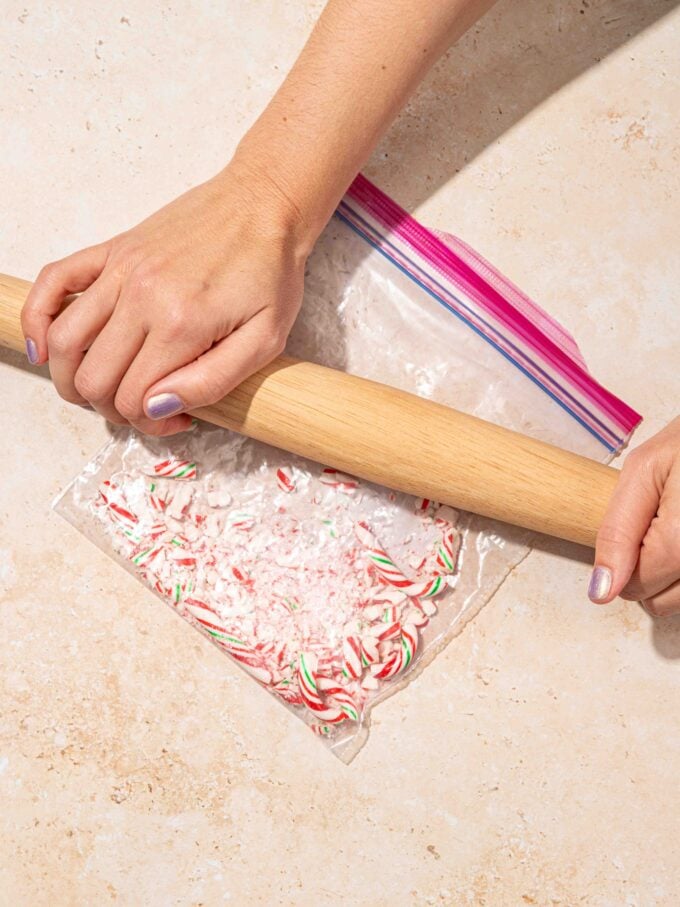 hand with rolling pin and candy canes